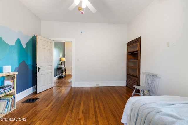 bedroom featuring hardwood / wood-style floors, visible vents, a ceiling fan, and baseboards