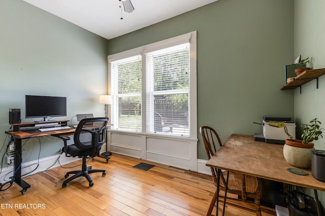 office featuring wood-type flooring, a ceiling fan, and visible vents