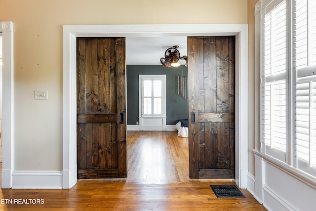 bathroom with visible vents, wood finished floors, and baseboards