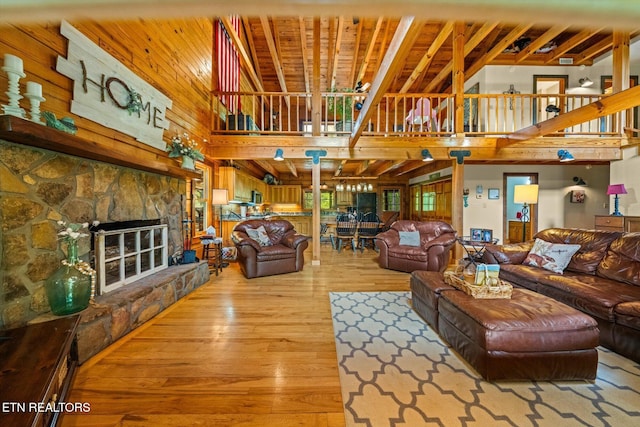 761 N Knob Creek Rd, Seymour, TN 37865 - living area with a high ceiling, light wood finished floors, stairway, a fireplace, and wood walls