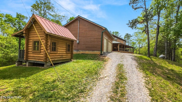 761 N Knob Creek Rd, Seymour, TN 37865 - view of side of home with driveway, metal roof, a yard, an outdoor structure, and log siding