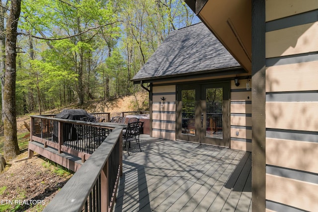 wooden deck featuring french doors and outdoor dining space