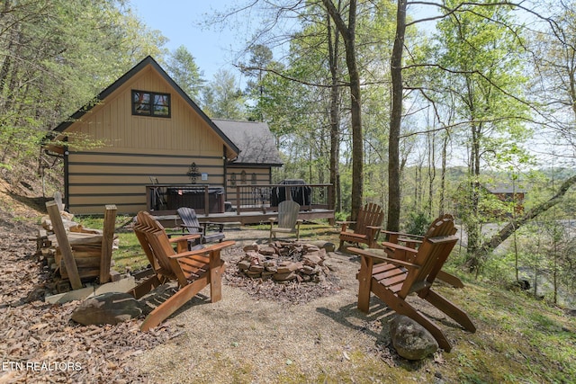 view of patio / terrace with a fire pit and a deck