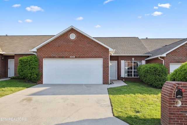 ranch-style home featuring an attached garage, a shingled roof, brick siding, and concrete driveway