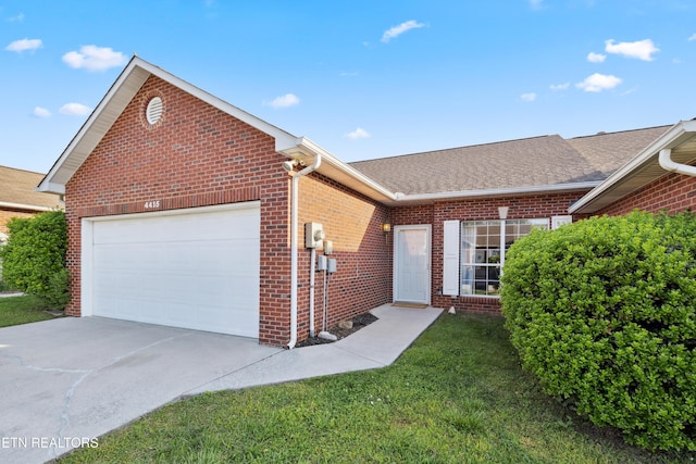 ranch-style house featuring roof with shingles, driveway, brick siding, a front yard, and a garage