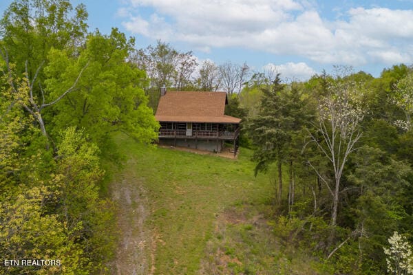 birds eye view of property with a view of trees
