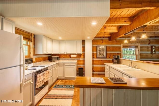 kitchen with white cabinets, light wood-style flooring, a sink, white appliances, and light countertops