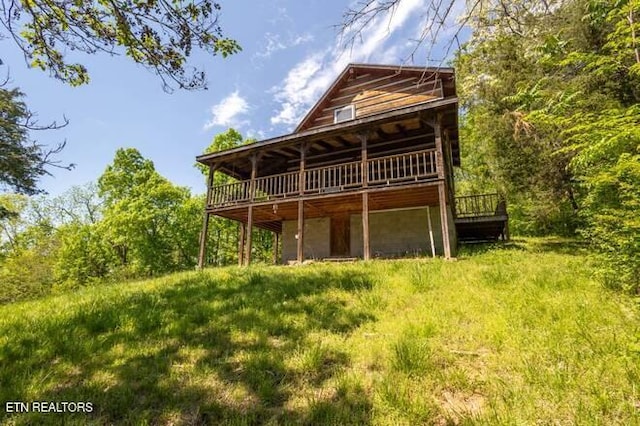 rear view of property with a wooden deck