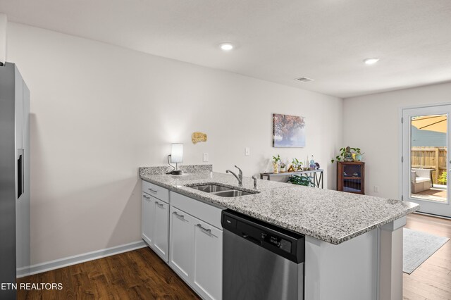 1423 Ridge Estates Dr, Athens, TN 37303 - kitchen with a sink, stainless steel appliances, a peninsula, dark wood-style flooring, and light stone counters