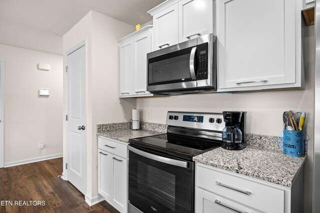 1423 Ridge Estates Dr, Athens, TN 37303 - kitchen with stainless steel appliances, white cabinetry, dark wood-type flooring, light stone counters, and baseboards