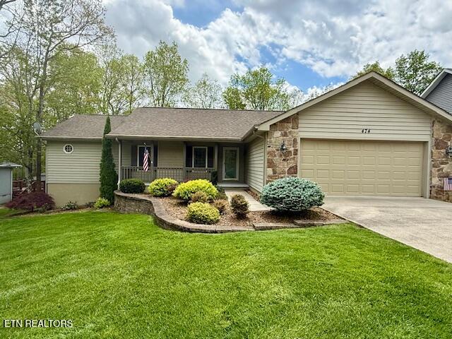 474 Lakeview Dr, Crossville, TN 38558 - ranch-style house with covered porch, a garage, driveway, stone siding, and a front yard
