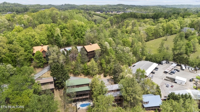 birds eye view of property with a view of trees