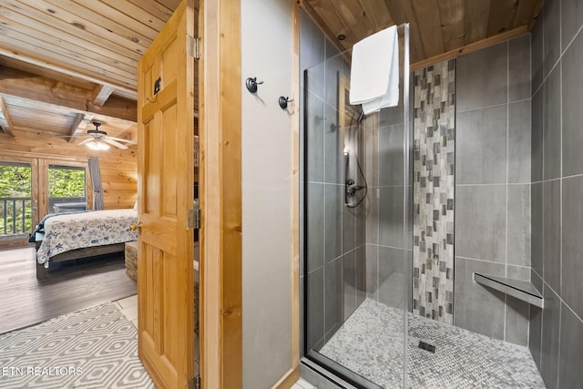 ensuite bathroom with wooden walls, wood ceiling, ensuite bathroom, and a stall shower