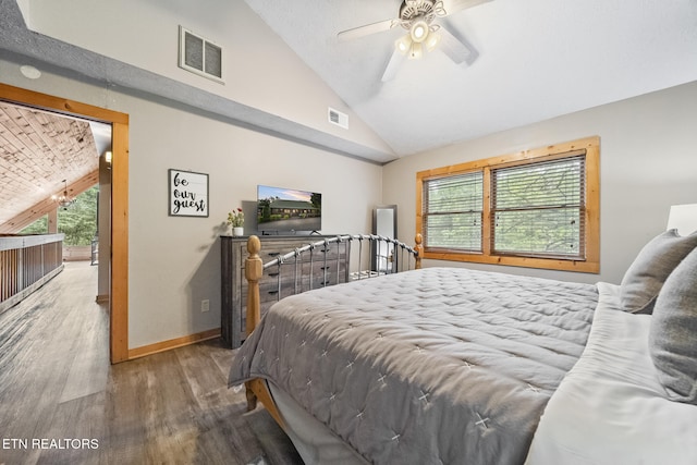 bedroom featuring visible vents, multiple windows, wood finished floors, and lofted ceiling