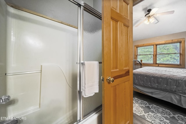 bathroom featuring ceiling fan, enclosed tub / shower combo, ensuite bath, and wood finished floors