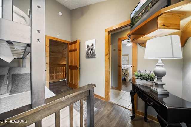 hallway with baseboards and wood finished floors