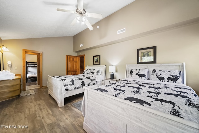 bedroom with visible vents, a ceiling fan, lofted ceiling, and wood finished floors