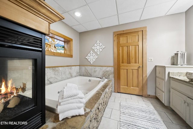 full bathroom with tile patterned flooring, vanity, a paneled ceiling, a whirlpool tub, and recessed lighting
