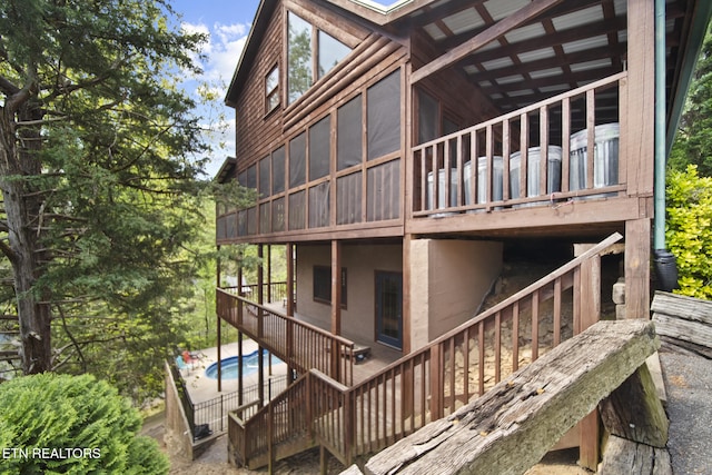 exterior space with a patio, a swimming pool, and stairs