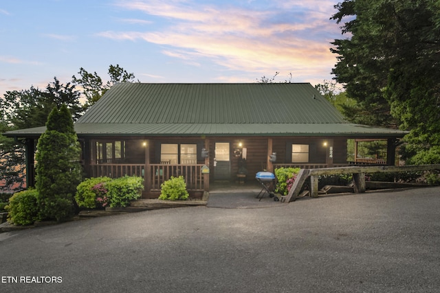 view of front facade with covered porch and metal roof