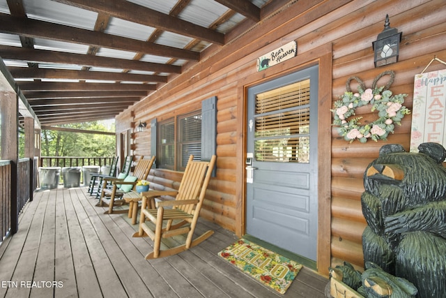 wooden terrace featuring covered porch