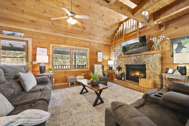 living room with plenty of natural light, wood walls, ceiling fan, and wooden ceiling