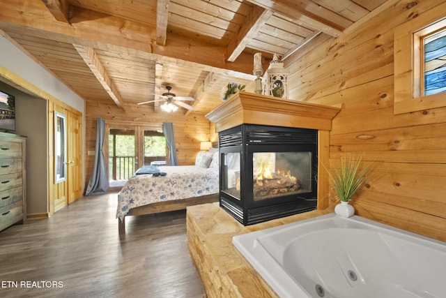 bedroom featuring wooden walls, wood ceiling, access to outside, and beamed ceiling