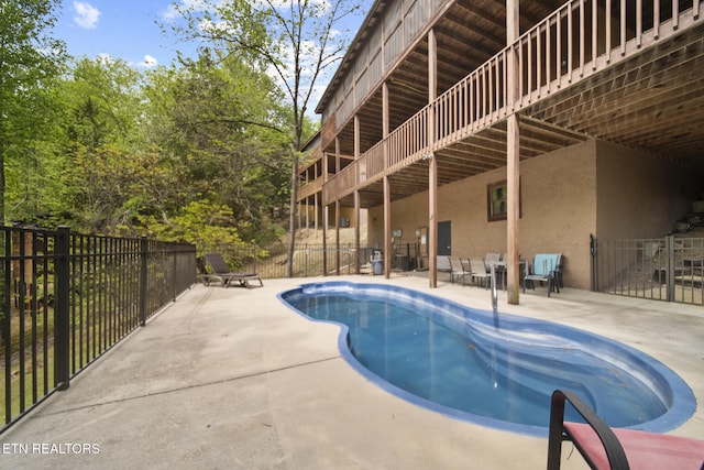 view of swimming pool featuring a fenced in pool, a patio area, and fence