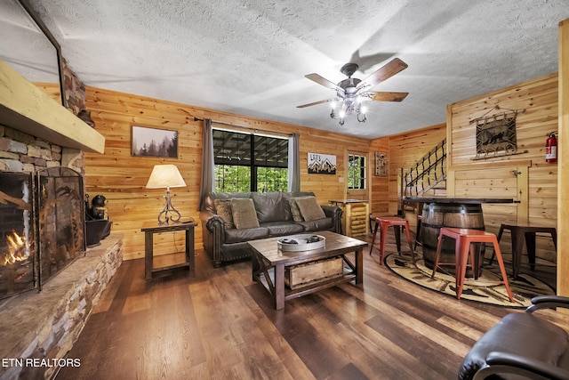 901 Sunrise Blvd, Sevierville, TN 37862 - living area featuring wooden walls, a textured ceiling, ceiling fan, and wood finished floors