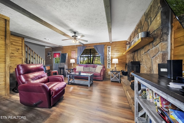 901 Sunrise Blvd, Sevierville, TN 37862 - living room with wood-type flooring, ceiling fan, wood walls, and a fireplace