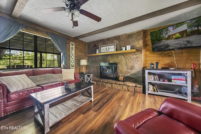 901 Sunrise Blvd, Sevierville, TN 37862 - living area featuring wood finished floors, beam ceiling, ceiling fan, wooden walls, and a textured ceiling