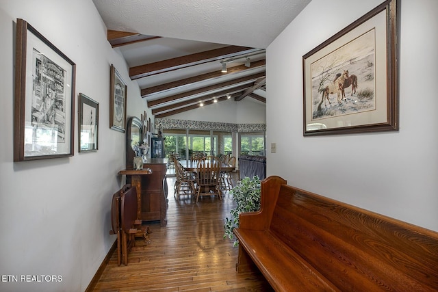 corridor featuring baseboards, vaulted ceiling with beams, and dark wood-type flooring