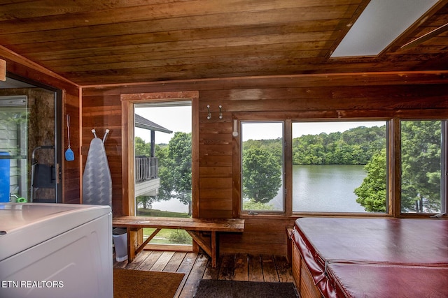 sunroom featuring washer / clothes dryer and a water view
