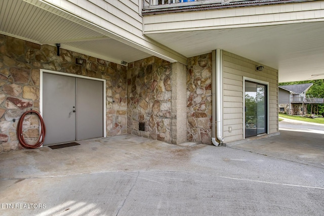 property entrance with stone siding
