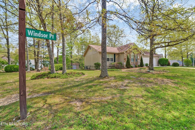 11 Windsor Pt, Crossville, TN 38558 - view of front of home with an attached garage and a front lawn