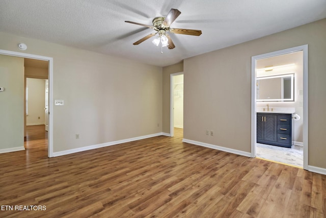 11 Windsor Pt, Crossville, TN 38558 - unfurnished bedroom with ceiling fan, wood finished floors, a sink, baseboards, and ensuite bath