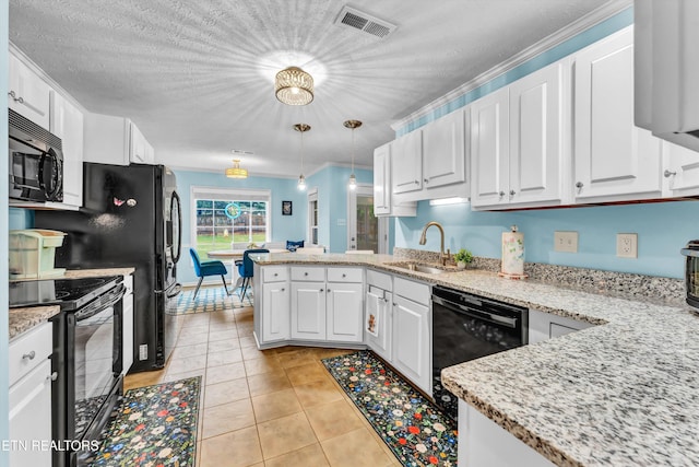 kitchen featuring a peninsula, white cabinetry, black appliances, and a sink