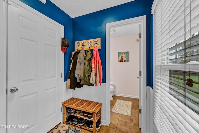 mudroom featuring tile patterned floors and wainscoting
