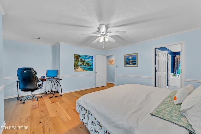 bedroom with a textured ceiling, baseboards, ornamental molding, ceiling fan, and wood finished floors