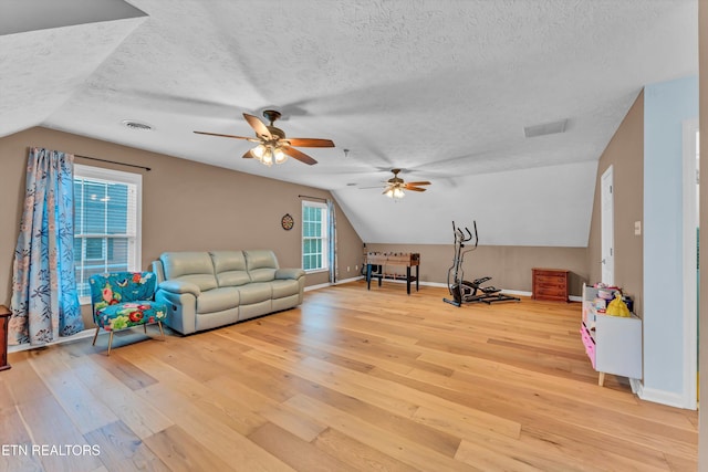 interior space featuring a textured ceiling and vaulted ceiling