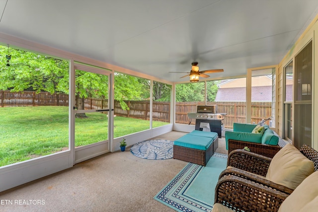 sunroom with ceiling fan and outdoor lounge area