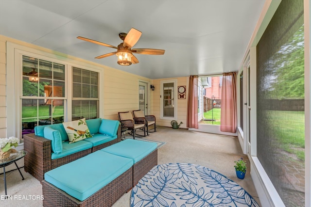 sunroom / solarium with ceiling fan and outdoor lounge area