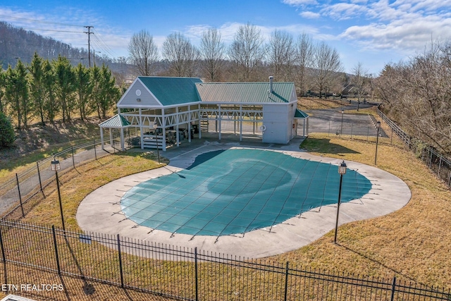 view of pool with stairway, fence, a fenced in pool, and a lawn