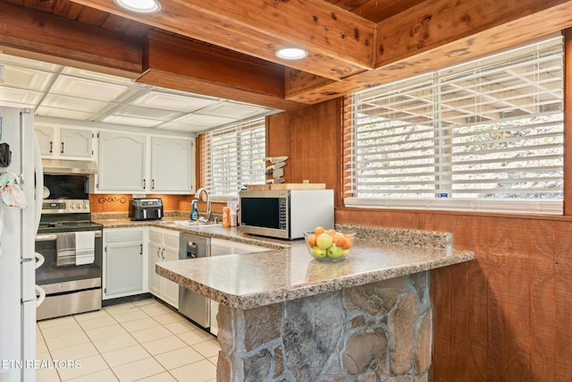 1122 Ski Mountain Rd, Gatlinburg, TN 37738 - kitchen with a sink, light tile patterned floors, stainless steel appliances, a peninsula, and under cabinet range hood