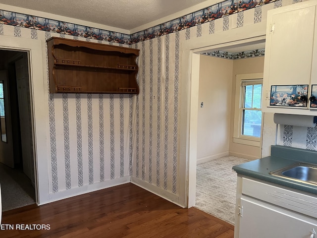 922 W Central Ave, Lafollette, TN 37766 - dining room featuring dark wood-type flooring, wallpapered walls, a textured ceiling, and baseboards