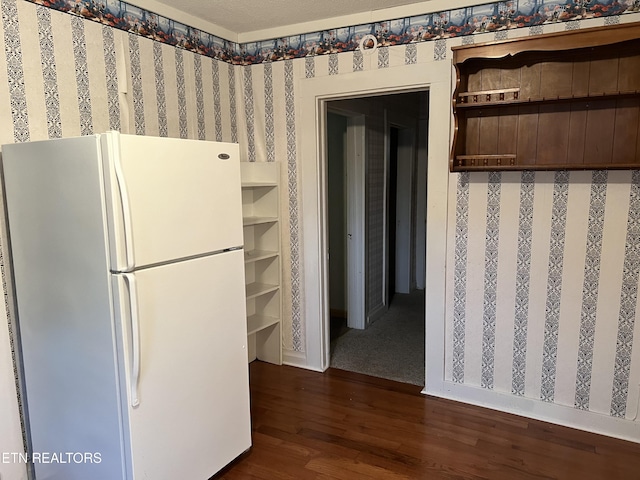 922 W Central Ave, Lafollette, TN 37766 - kitchen with open shelves, wallpapered walls, freestanding refrigerator, and dark wood-type flooring