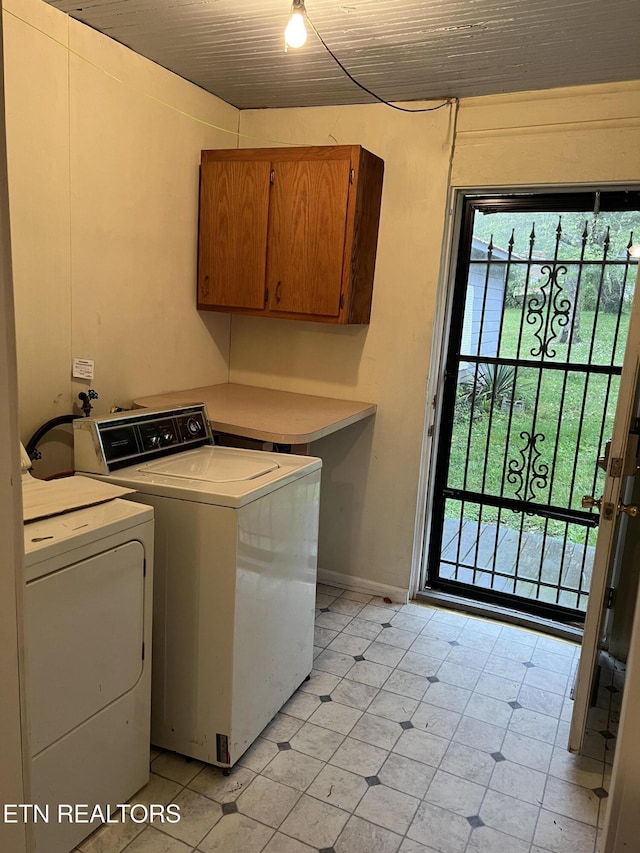 922 W Central Ave, Lafollette, TN 37766 - washroom featuring light tile patterned flooring, washing machine and dryer, baseboards, cabinet space, and wooden ceiling