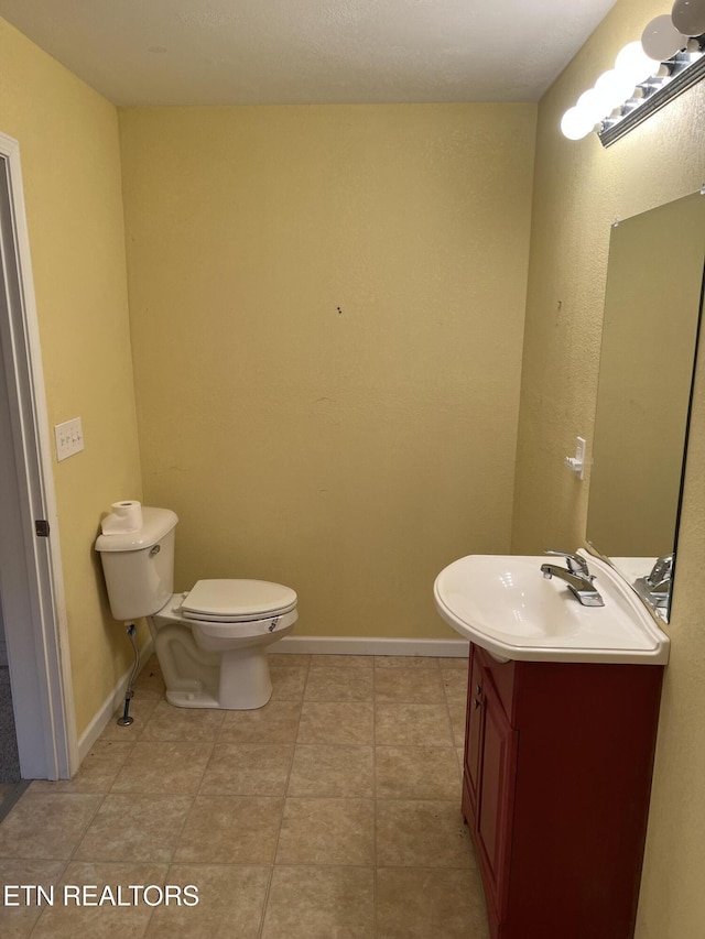 922 W Central Ave, Lafollette, TN 37766 - half bath featuring baseboards, vanity, tile patterned flooring, and toilet