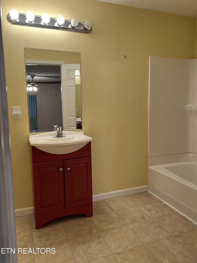 922 W Central Ave, Lafollette, TN 37766 - bathroom with tile patterned flooring, baseboards, vanity, and bathtub / shower combination