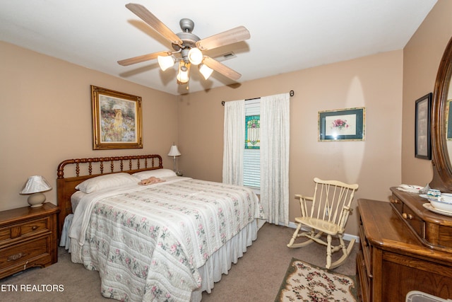 carpeted bedroom featuring visible vents and ceiling fan